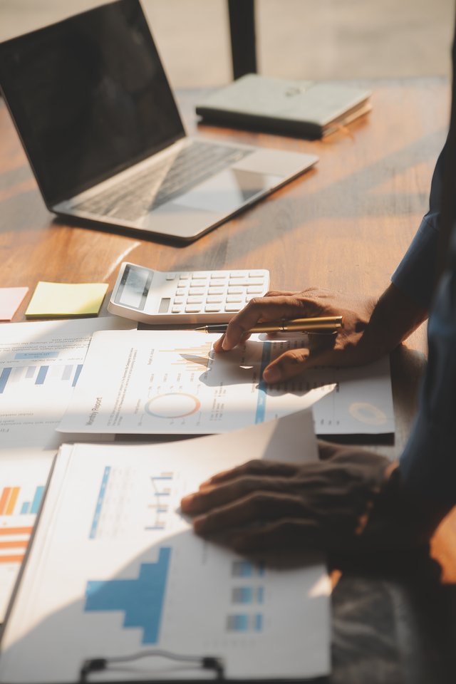 vecteezy_close-up-of-business-team-analyzing-income-charts-and-graphs_39953260
